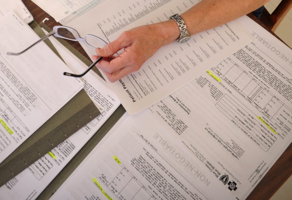 Medical bills are spread out on the kitchen table of a cancer patient. (AP File Photo)