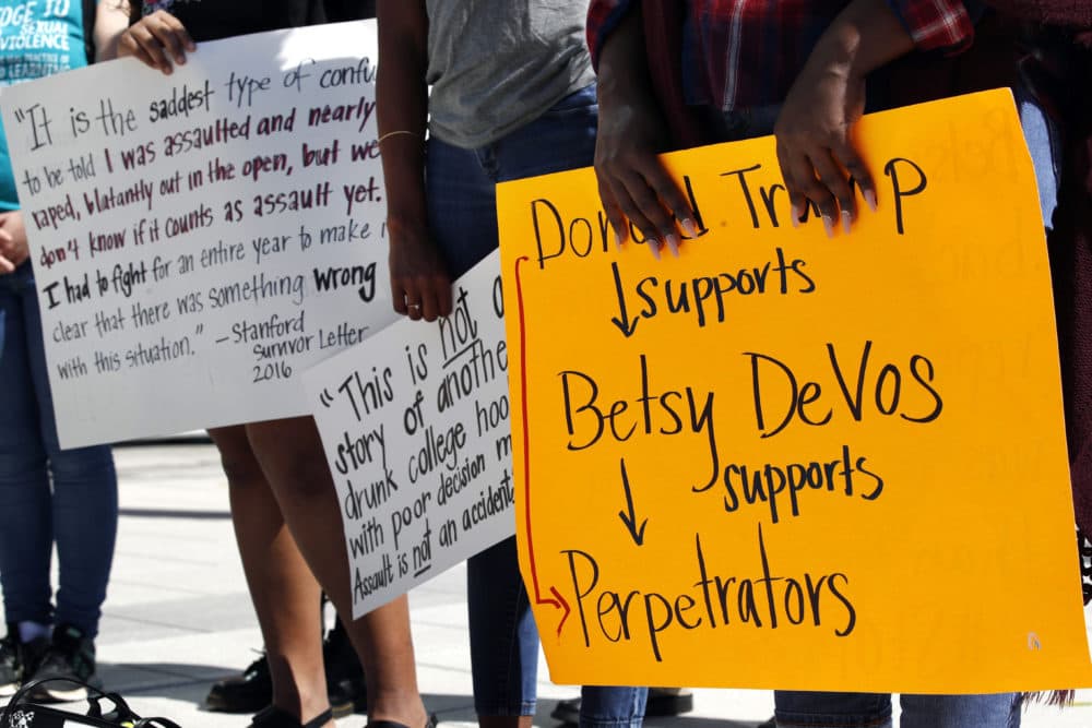 People gather to protest proposed changes to Title IX before a speech by Education Secretary Betsy DeVos, Thursday, Sept. 7, 2017, at George Mason University Arlington, Va., campus. DeVos plans to end the Obama administration's rules for investigating allegations of sexual violence on campus. (Jacquelyn Martin/AP)