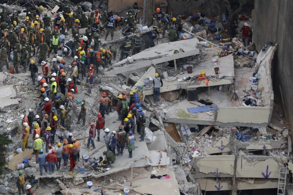 Rescue workers searched for people trapped inside a collapsed building in the Del Valle area of Mexico City on Sept. 20, 2017, the day after a 7.1 magnitude earthquake struck the area. (Rebecca Blackwell/AP)