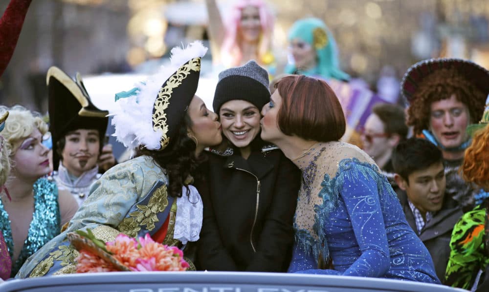 Actress Mila Kunis is kissed by actors dressed in drag during the Hasty Pudding Parade in January 2018. (Charles Krupa/AP)