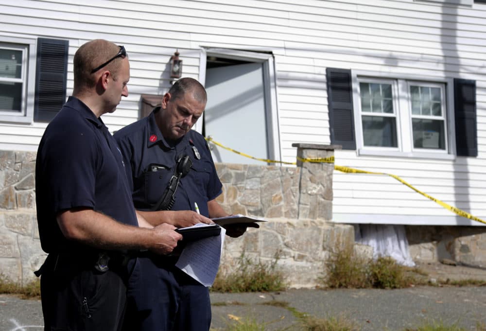 Fire inspectors take notes outside a house that was blown off its foundation on Kingston Street in Lawrence, Mass., Friday, Sept. 14, 2018. (Mary Schwalm/AP)