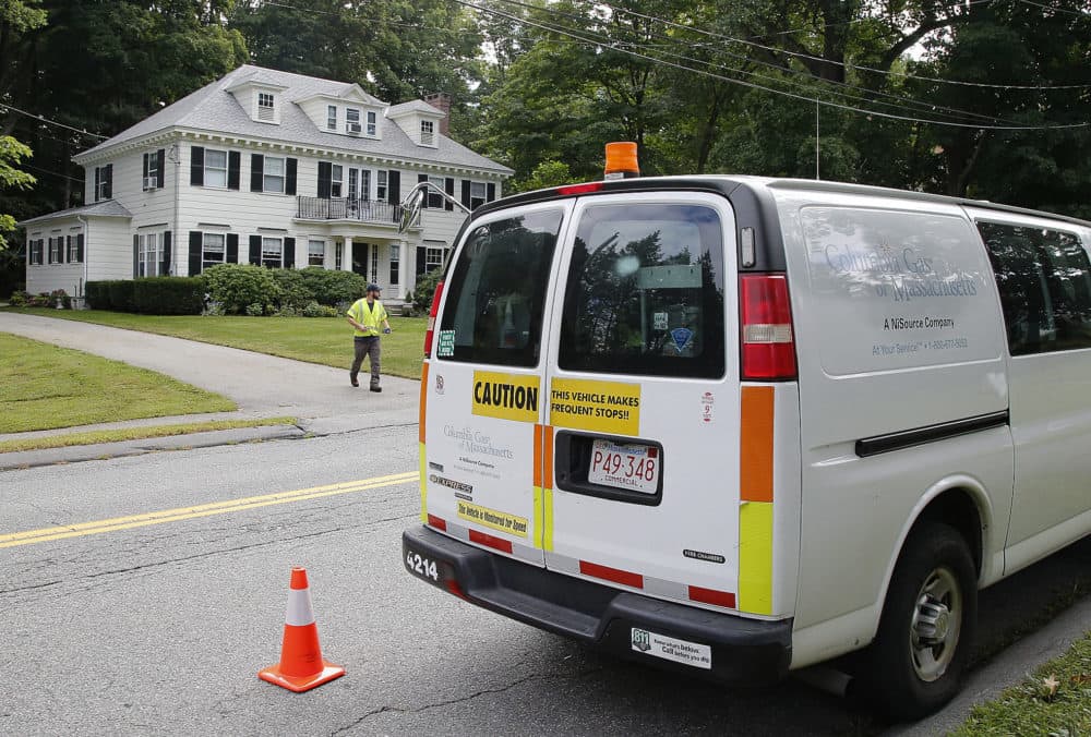 An employee of Columbia Gas leaves a house after shutting off the gas Friday in Andover. (Winslow Townson/AP)