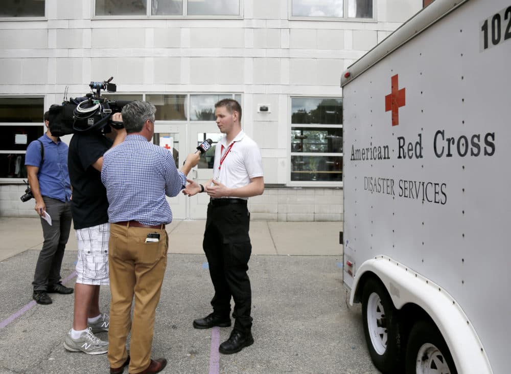 Red Cross employee Larry French briefs the media outside the Parthum School in Lawrence, Mass., Friday, Sept. 14, 2018. (Mary Schwalm/AP)