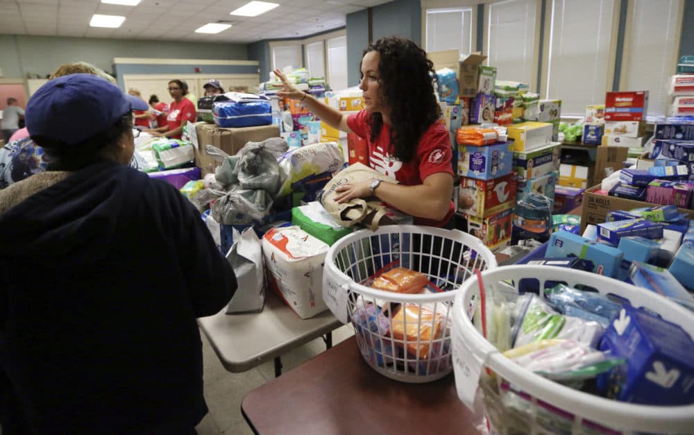 Volunteers at the Senior Center in Lawrence hand out food and supplies Tuesday, in the wake of last week's gas explosions and house fires in the Merrimack Valley. (Elise Amendola/AP/file)