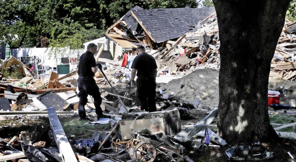 Fire investigators pause while searching the debris at a home which exploded last week following a gas line failure in Lawrence, Mass., Friday, Sept. 21, 2018. Nearly 9,000 homes and businesses may be without gas for weeks as investigators continue to probe what set off the explosions. (Charles Krupa/AP)