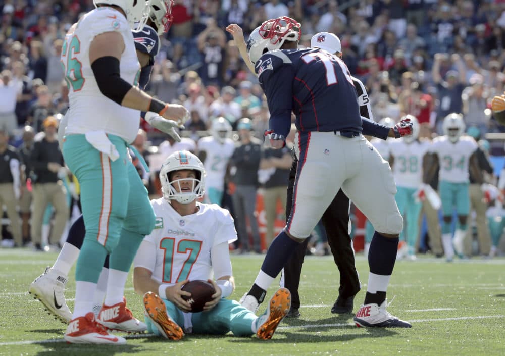 New England Patriots defensive tackle Adam Butler, right, celebrates after sacking Miami Dolphins quarterback Ryan Tannehill (17) during the second half of an NFL football game, Sunday, Sept. 30, 2018, in Foxborough, Mass. (AP Photo/Elise Amendola)