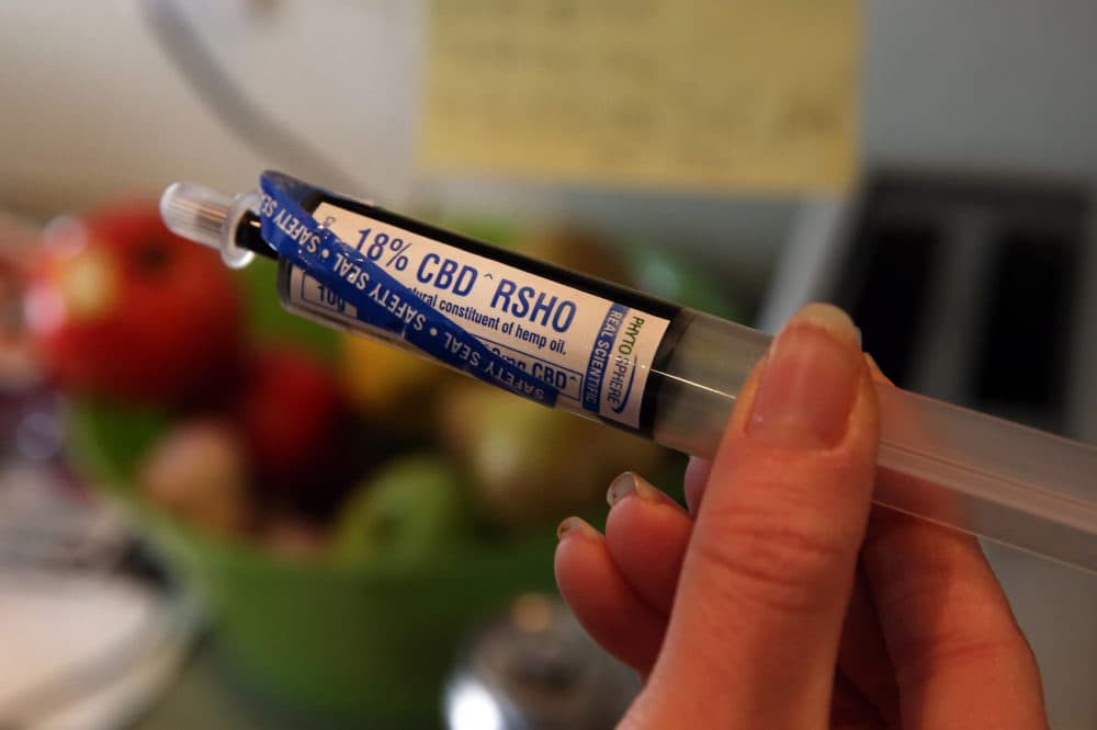 FILE - In this April 29, 2014 file photo, an oral administration syringe loaded with high CBD hemp oil for treating a severely-ill child is shown at a private home in Colorado Springs, Colo. Colorado is poised to award more than $8 million for medical marijuana research, a step toward addressing complaints that little is known about pot's medical potential. Among the research projects poised for approval on Wednesday, Dec. 17, 2014, are one for pediatric epilepsy patients, and another for children with brain tumors. (AP Photo/Brennan Linsley, File)