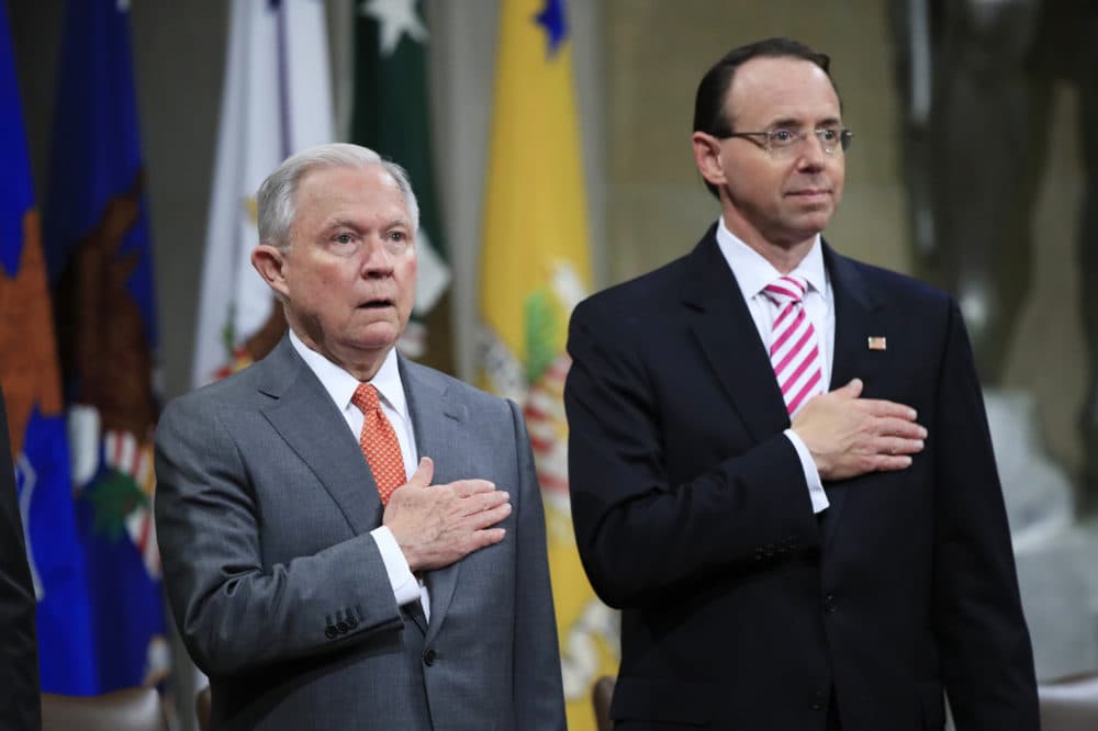 Attorney General Jeff Sessions, left, and Deputy Attorney General Rod Rosenstein, put their hands over their heart as they sing the National Anthem during a Religious Liberty Summit at the Department of Justice, Monday, July 30, 2018. Sessions says there’s a “dangerous movement” to erode protections for Americans to worship and believe as they choose.  (AP Photo/Manuel Balce Ceneta)