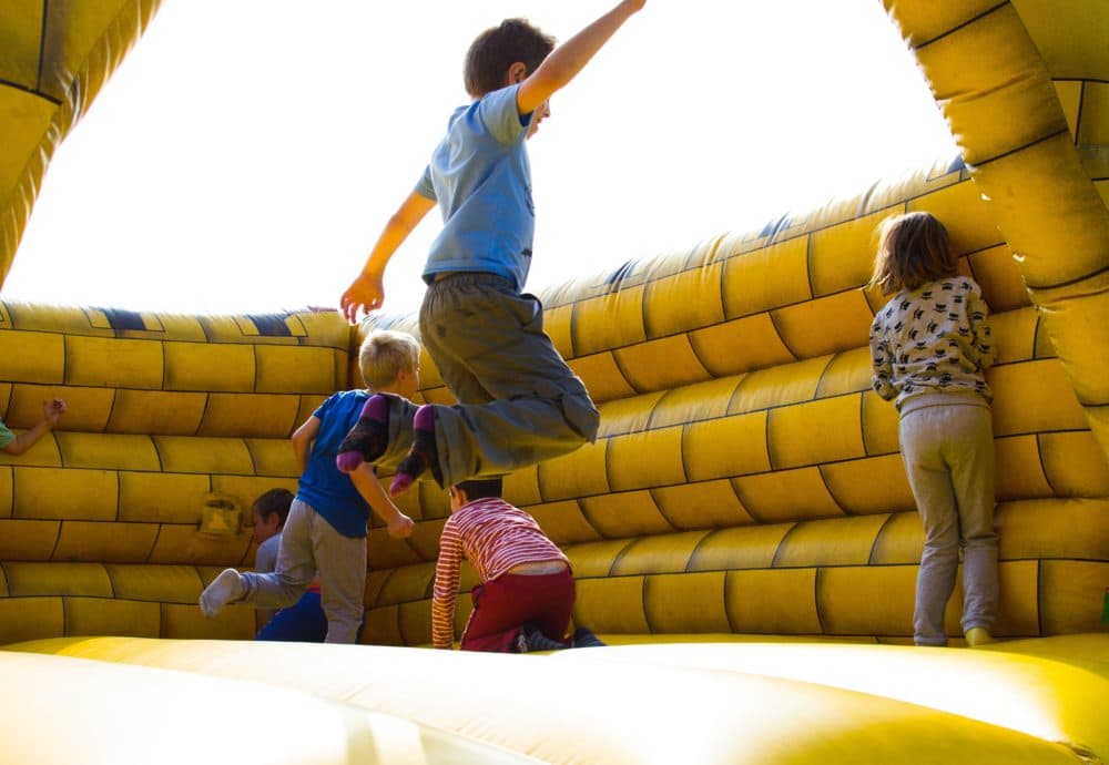 Children play in a bounce house. (Pexels)