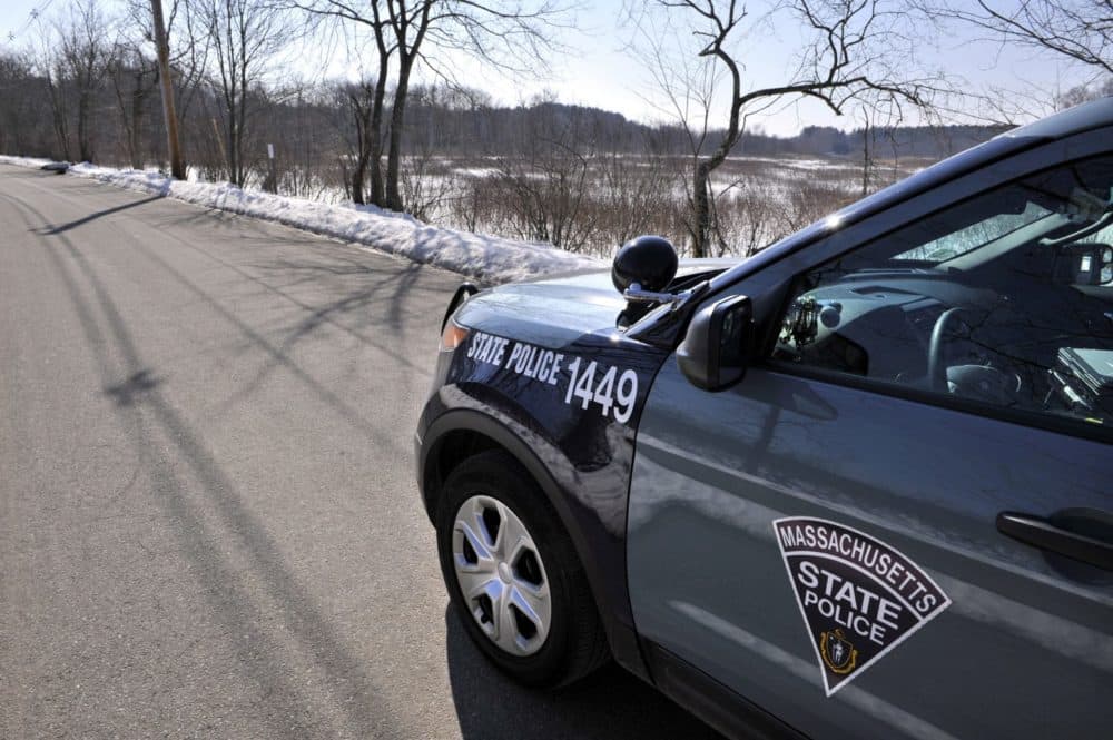 A state police vehicle sits on Water Row in Wayland, Mass. in 2013. (Josh Reynolds/The Boston Globe, via AP pool)