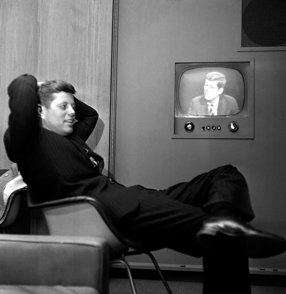 In April 1960, Sen. John F. Kennedy, Democratic presidential nominee, sits next to a playback of his televised appearance in Milwaukee, Wis. for the Wisconsin presidential primary two days later. (AP)