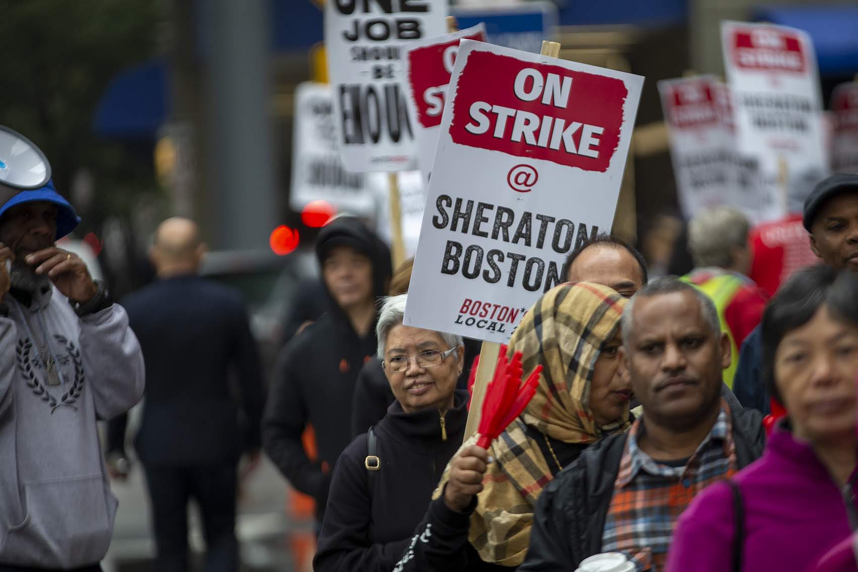 Mei Leung, left of the &quot;On Strike&quot; sign, a housekeeper at the Sheraton Boston, has been picketing regularly in front of the hotel. (Jesse Costa/WBUR)