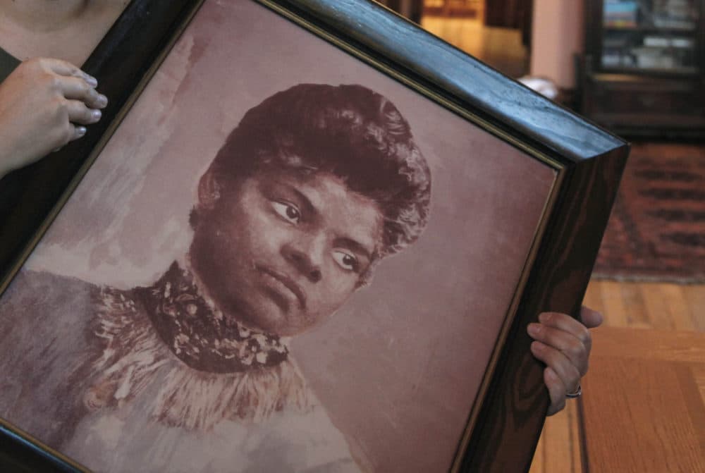In this Dec. 2, 2011 photo, Michelle Duster, great-granddaughter of civil rights pioneer Ida B. Wells, holds a portrait of Wells. (Charles Rex Arbogast/AP)