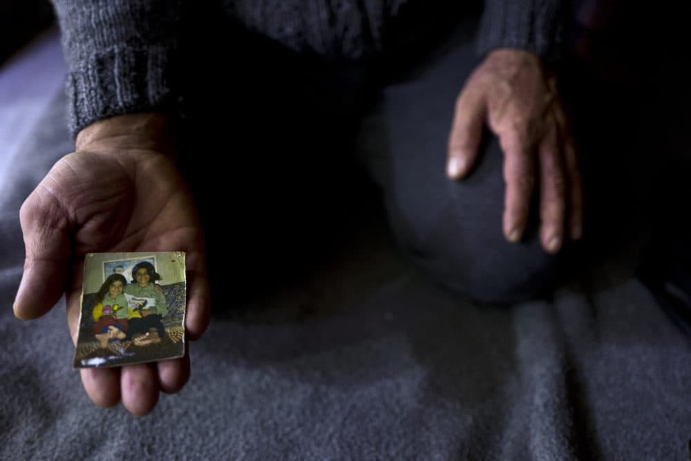 In this Thursday, Jan. 19, 2017 photo, Ibraheem Ghareeb, 55, a Syrian refugee, shows a photograph of his daughters at his tent in Kalochori refugee camp on the outskirts of the northern Greek city of Thessaloniki.  &quot;This is the only physical memory that I have left of my late daughter Layla and it never leave my sight.&quot; Ibraheem said. (Muhammed Muheisen/AP)