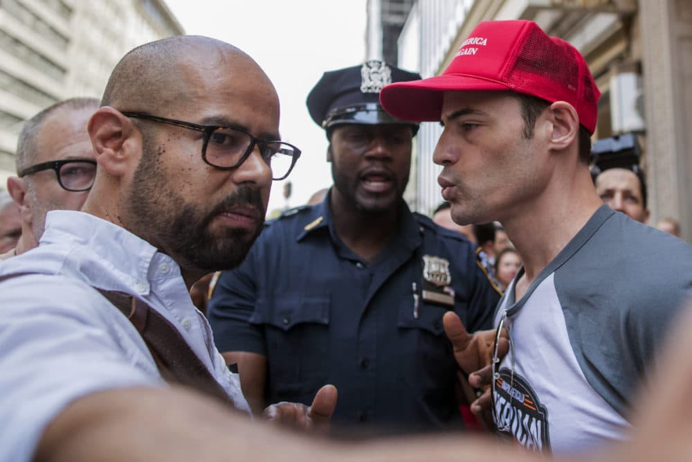 A police officer separates a pro Trump supporter, right, who was taunting one of the organizers of the &quot;100 Days of Failure&quot; protest and march, Saturday, April 29, 2017, in New York. (Mary Altaffer/AP)