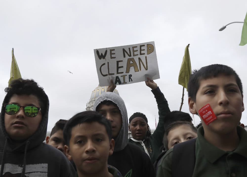 Students listen to speakers at a rally for clean energy in San Francisco, Wednesday, Feb. 28, 2018. California stands in &quot;complete opposition&quot; to a Trump administration plan to scrap a policy slashing climate-changing emissions from power plants. (Jeff Chiu/AP)