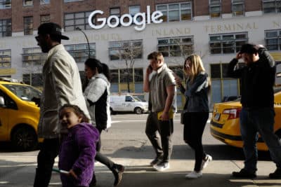 FILE - In this Dec. 4, 2017, file photo, people walk by the the Google office building on Ninth Avenue in New York. (AP Photo/Mark Lennihan, File)
