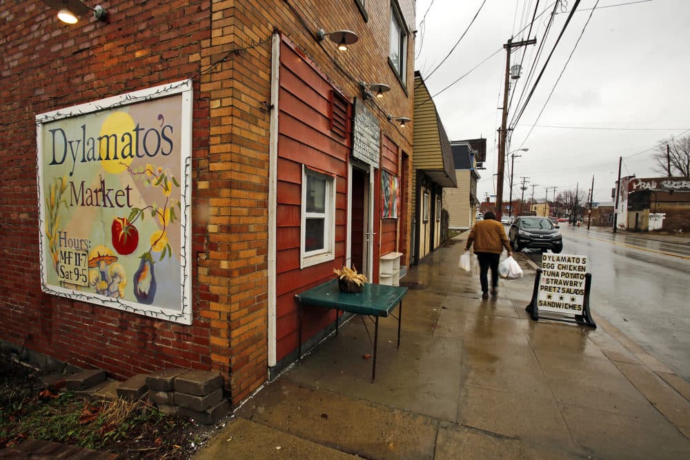 In this March 1, 2018 photo, a customer leaves Dylamatos Market in Pittsburgh. About a quarter of the market's' customers pay with benefits from the federal Supplemental Nutrition Assistance Program. (Gene J. Puskar/AP)
