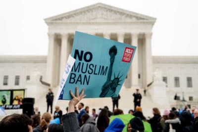 In this April 25, 2018 file photo, a person holds up a sign that reads &quot;No Muslim Ban&quot; during an anti-Muslim ban rally as the Supreme Court hears arguments about wether President Donald Trump's ban on travelers from several mostly Muslim countries violates immigration law or the Constitution in Washington. (Andrew Harnik/AP)