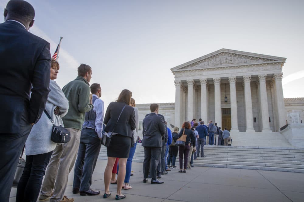 People line up at the Supreme Court on the first day of the new term, on Capitol Hill in Washington, Monday, Oct. 1, 2018. Amid the political chaos of Judge Brett Kavanaugh's nomination, the high court's work begins with only eight justices on the bench, four conservatives and four liberals. (AP Photo/J. Scott Applewhite)