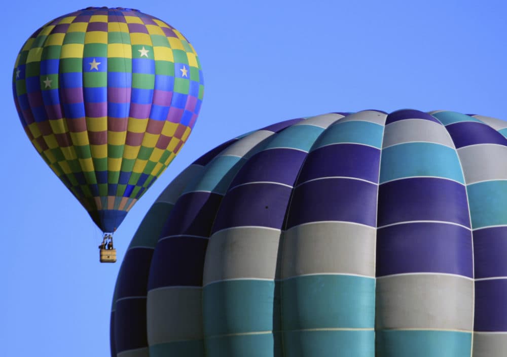 Hot air balloons participating in the Albuquerque International Balloon Fiesta float over Albuquerque, N.M., Oct. 10, 2017. The 47th Albuquerque International Balloon Fiesta is set to start Saturday, Oct. 6, 2018. (Susan Montoya Bryan/AP)