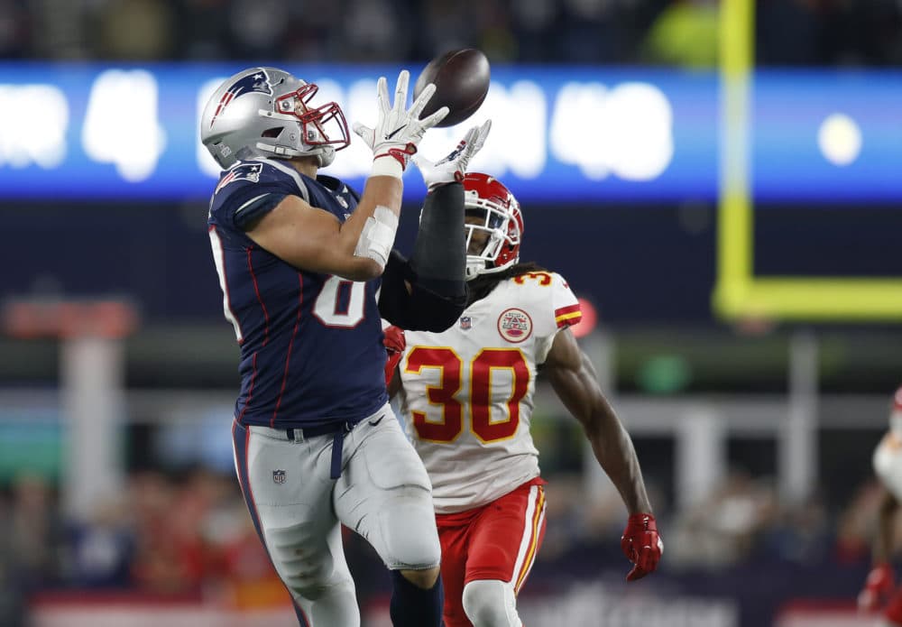 New England Patriots tight end Rob Gronkowski, left, catches a pass in front of Kansas City Chiefs safety Josh Shaw (30) during the second half of an NFL football game, Sunday, Oct. 14, 2018, in Foxborough. (Michael Dwyer/AP)