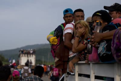 Migrants hitch rides on passing truck as they continue on their journey after Mexican police briefly blockaded the road to keep them from advancing, outside the town of Arriaga, Mexico, Saturday, Oct. 27, 2018. Hundreds of Mexican federal officers carrying plastic shields briefly blocked the caravan of Central American migrants from continuing toward the United States, after several thousand of the migrants turned down the chance to apply for refugee status and obtain a Mexican offer of benefits. (AP Photo/Rebecca Blackwell)