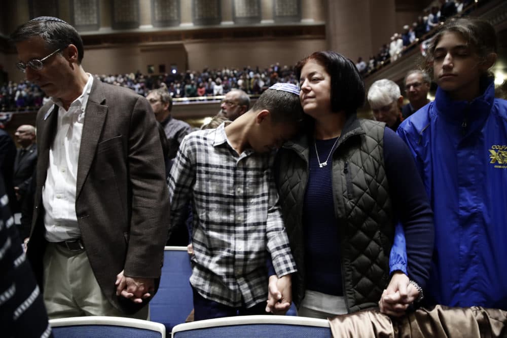 People mourn in Soldiers and  Sailors Memorial Hall and Museum during a community gathering held in the aftermath of Saturday's deadly shooting at the Tree of Life Synagogue in Pittsburgh, Sunday, Oct. 28, 2018. (Matt Rourke/AP)