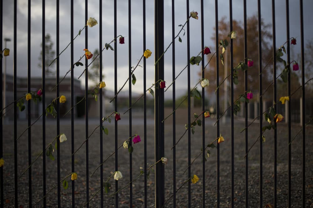 Roses adorn a makeshift memorial near the Inland Regional Center, Friday, Dec. 11, 2015, in San Bernardino, Calif. (AP Photo/Jae C. Hong)