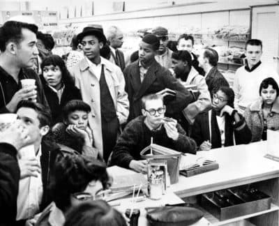 Three African American girls sit next to a white boy at a lunch counter in Portsmouth, Va., as they participate in a sit-down strike in February 1960. The demonstrators are largely students.  (AP Photo)