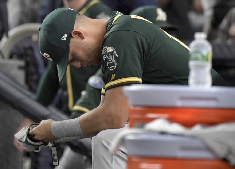 Oakland Athletics' Chad Pinder sits on the bench after the A's lost to the New York Yankees 7-2 in the American League wild-card playoff baseball game on Wednesday. (AP/Bill Kostroun)