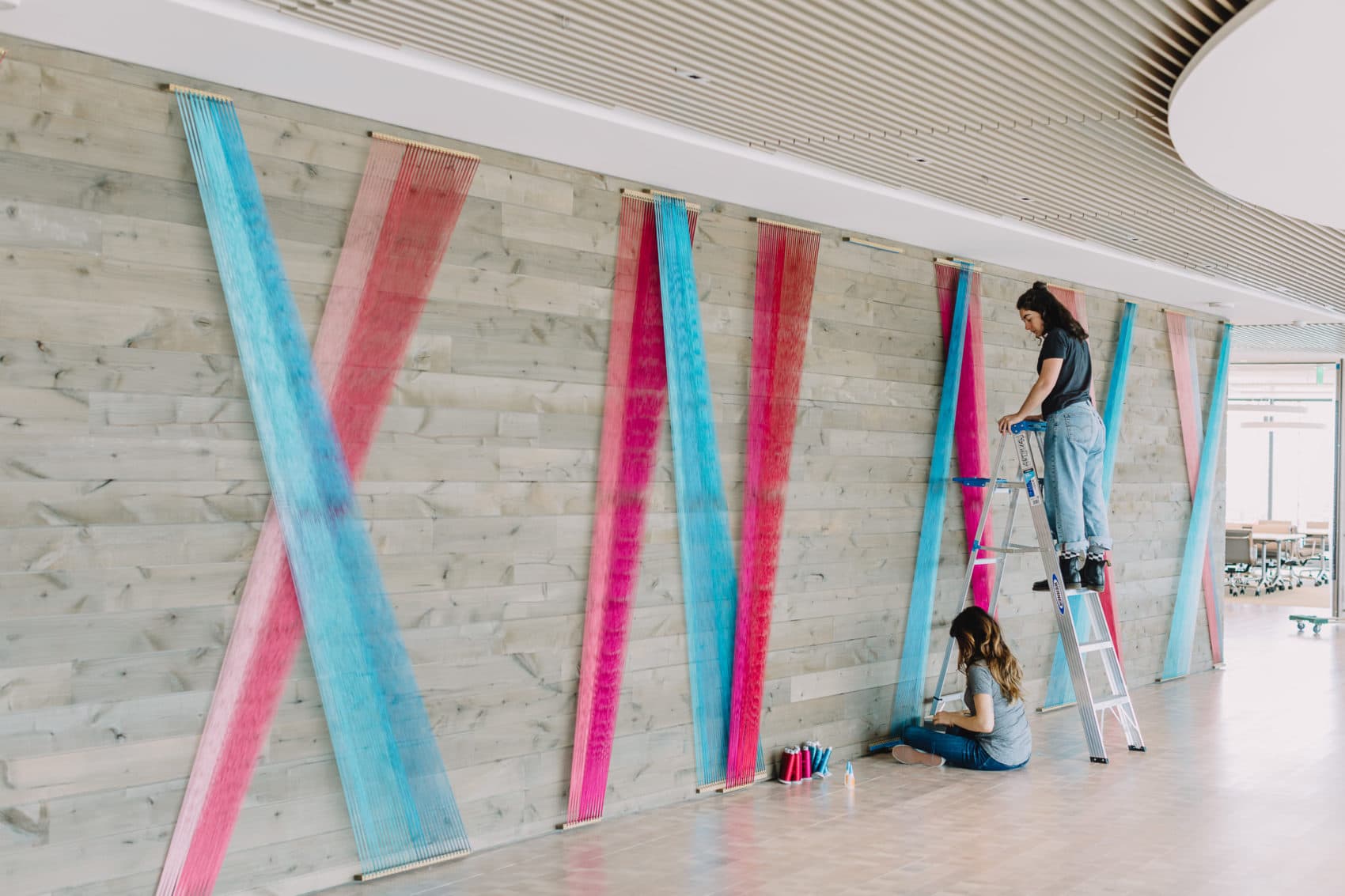 Artist Rachel Mica Weiss installs her fiber work at the Boston Consulting Group's new headquarters. (Courtesy Nicole Baas)