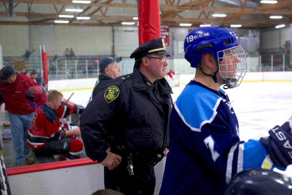 Arlington Police Lt. Rick Pedrini, left, watches a police vs. fire hockey game in 2016. (Courtesy of Melanie Mendez/Wicked Local)