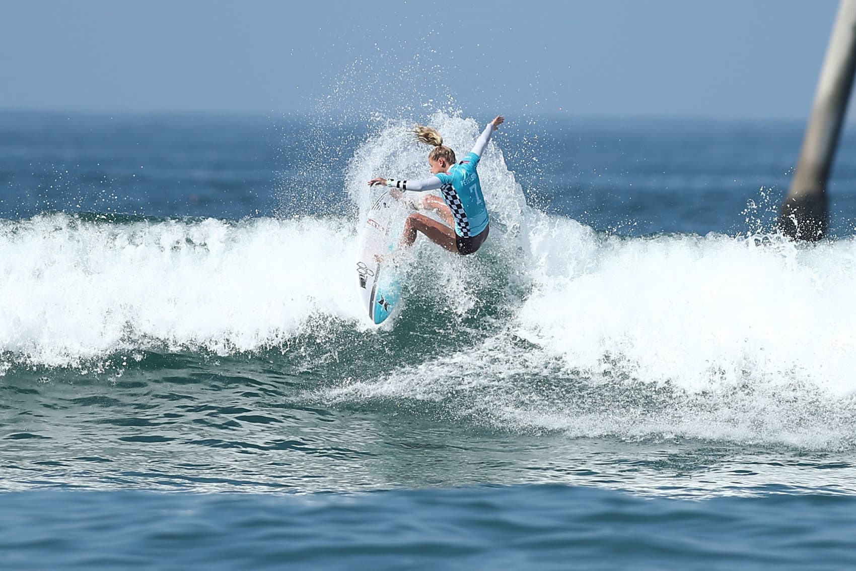 A surfer competes in the women's quarterfinals at the Vans U.S. Open of Surfing on Aug. 5, 2018 in Huntington Beach, California. Women competing at the highest levels of surfing will now win the same prize money as their male counterparts after a rules change took effect earlier this month. (Joe Scarnici/Getty Images)