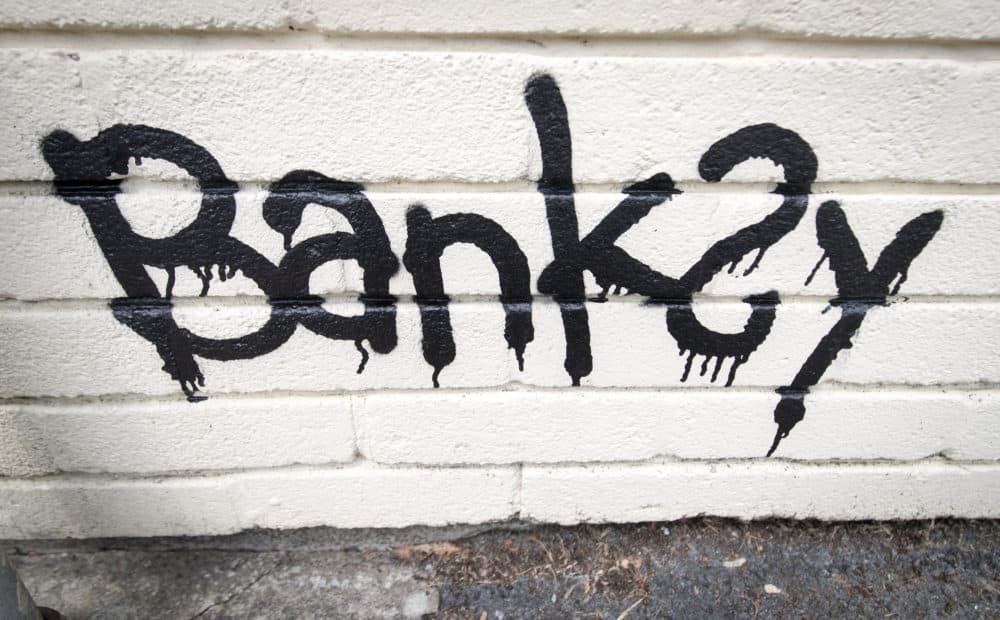 The name Banksy is left as part of a mural painted on the side of one of the classrooms at Bridge Farm Primary in Bristol, England on June 7, 2016. (Matt Cardy/Getty Images)