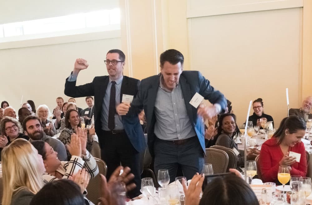 Donald McKay elementary school principal Jordan Weymer and director of operations Michael Munroe celebrate as their school is awarded the $100,000 Thomas W. Payzant School on the Move prize. (Courtesy of Edvestors)