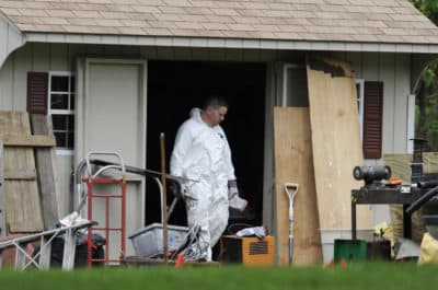 A law enforcement agent searches a shed behind the home of reputed Connecticut mobster Bobby Gentile in Manchester, Connecticut, on May 10, 2012. (Jessica Hill/AP)