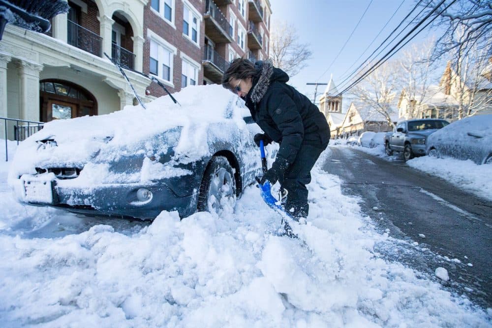 In March, a man shovels his car out of the snow on Park Vale Avenue in Allston. (Jesse Costa/WBUR)
