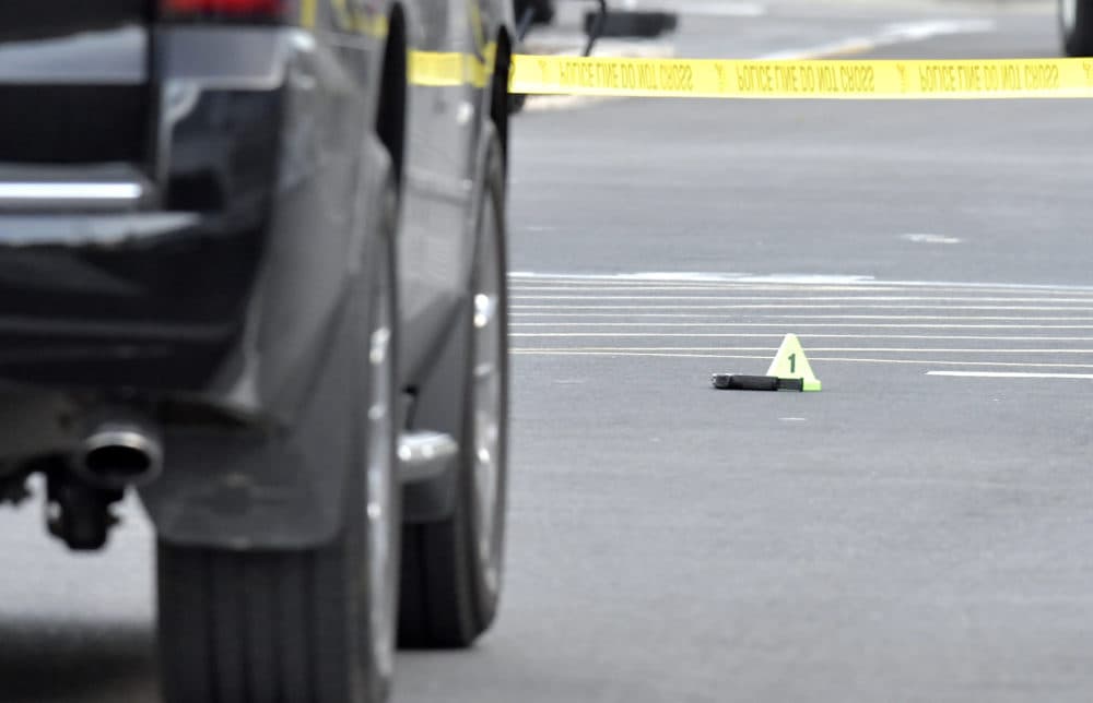 A suspect in a double homicide reportedly opened fire on a party after being asked to leave. Here, a gun lies on the ground next to an evidence marker outside of a Kroger Grocery in Jeffersontown, Ky., Wednesday, Oct. 24, 2018,. The shooting left two people dead, and the subject in custody. (Timothy D. Easley/AP)