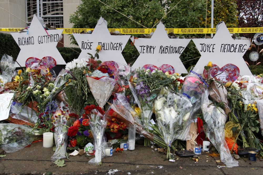 These are flowers and Stars of David on Thursday, Nov. 1, 2018, at a makeshift memorial outside the Tree of Life Synagogue to the 11 people killed Oct. 27, 2018 while worshiping in the Squirrel Hill neighborhood of Pittsburgh. (Gene J. Puskar/AP)