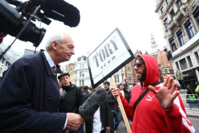 TV presenter Jon Snow speaks to a protester during the ceremonial funeral of former British Prime Minister Margaret Thatcher on April 17, 2013 in London. (Clive Rose/Getty Images)