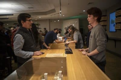 In Leicester, Cultivate workers help customers at the counter during the first day of recreational marijuana sales in Massachusetts. (Jesse Costa/WBUR)