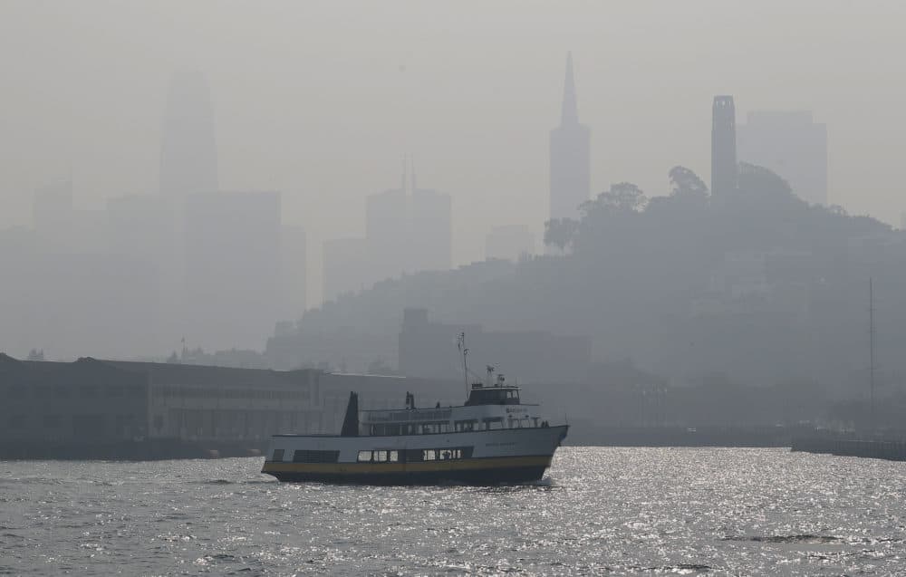 The skyline is obscured by smoke and haze from wildfires as a tour boat makes its way along the waterfront Thursday, Nov. 15, 2018, in San Francisco. Recurring wildfires are sparking concern among medical experts about potentially major health consequences. (Eric Risberg/AP)