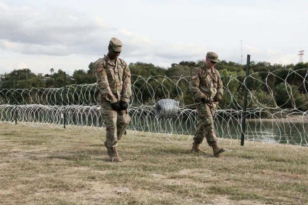 Soldiers from the Kentucky-based 19th Engineer Battalion work in a public park in Laredo, Texas, where they are installing barbed and concertina wire on Nov. 17, 2018. The soldiers are some of the thousands of U.S. troops deployed to the U.S.-Mexico border as part of a mission ordered by President Trump to toughen the frontier and provide engineering and logistical support to Customs and Border Protection agents. (Thomas Watkins/AFP/Getty Images)