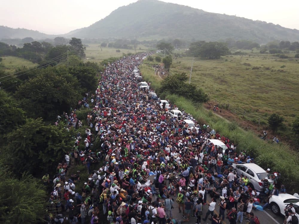 Members of a U.S.-bound migrant caravan stand on a road after federal police briefly blocked their way outside the town of Arriaga, Saturday, Oct. 27, 2018. (Rodrigo Abd/AP)