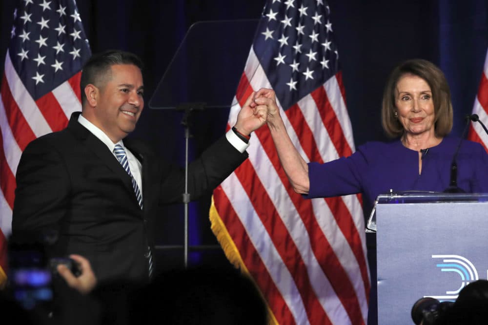 DCCC Chair Ben Ray Luján and House Democratic Leader Nancy Pelosi gesture after speaking to a crowd of volunteers and supporters at an election night event at the Hyatt Regency Hotel, on Tuesday, Nov. 6, 2018, in Washington. (Jacquelyn Martin/AP)