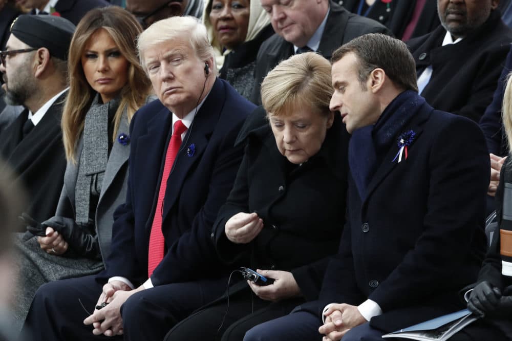French President Emmanuel Macron, German Chancellor Angela Merkel, U.S. President Donald Trump and first lady Melania Trump attend a commemoration ceremony for Armistice Day, 100 years after the end of the First World War at the Arc de Triomphe in Paris, France, Sunday, November 11, 2018. (Benoit Tessier/Pool Photo via AP)