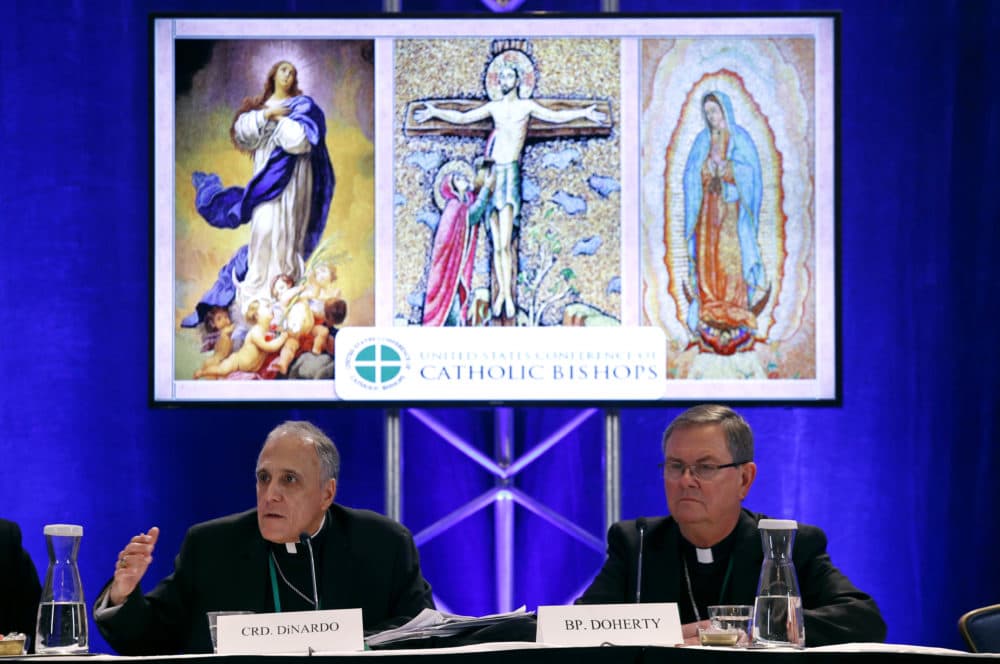Cardinal Daniel DiNardo of the Archdiocese of Galveston-Houston, left, president of the United States Conference of Catholic Bishops, speaks alongside Bishop Timothy Doherty of the Diocese of Lafayette-in-Indiana at a news conference during the USCCB's annual fall meeting, Monday, Nov. 12, 2018, in Baltimore. (Patrick Semansky/AP)
