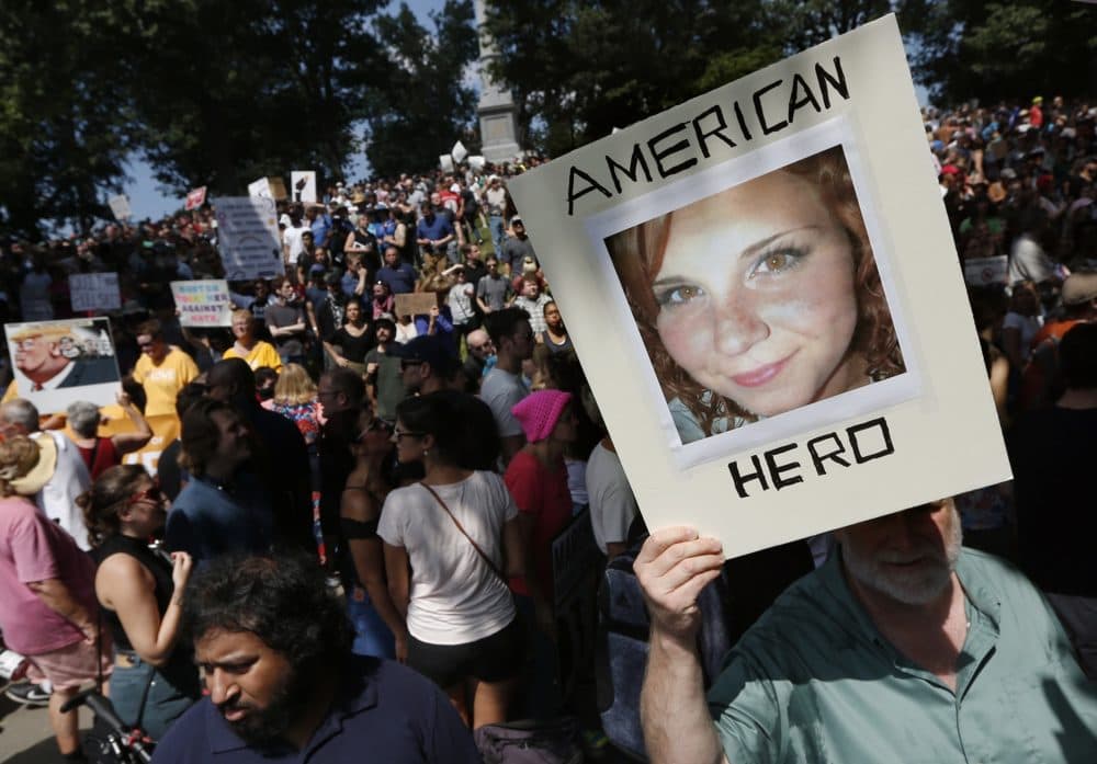 In this Saturday, Aug. 19, 2017, file photo, a counter-protester holds a photo of Heather Heyer on Boston Common at a &quot;Free Speech&quot; rally organized by conservative activists, in Boston. Heyer was killed when a car, driven by James Alex Fields Jr., plowed into a group of people during protests in Charlottesville, Va. (Michael Dwyer/AP)