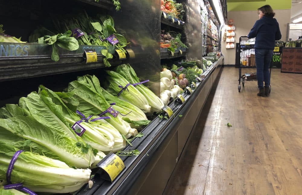 Romaine lettuce still sits on the shelves as a shopper walks through the produce area of an Albertsons market Tuesday, Nov. 20, 2018, in Simi Valley, Calif. (Mark J. Terrill/AP)